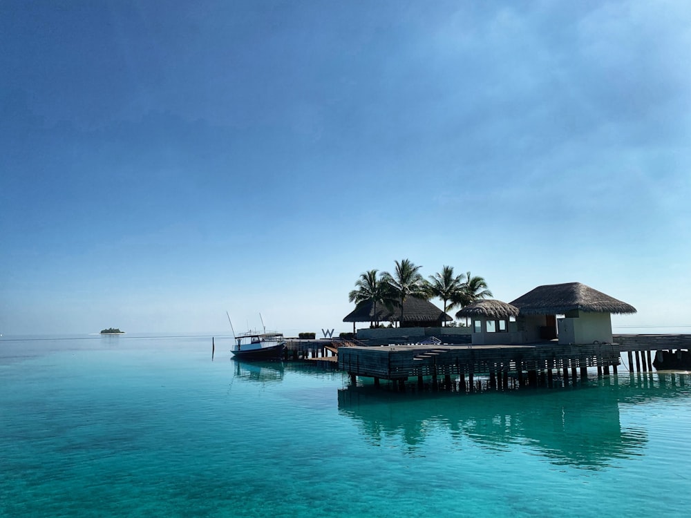 brown wooden house on body of water during daytime