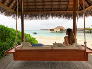 woman in white bikini lying on white bed