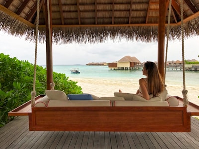 woman in white bikini lying on white bed