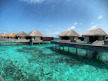 brown wooden house on body of water under blue sky during daytime