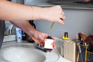 person holding orange and black plastic tool