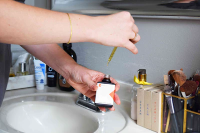 person holding orange and black plastic tool