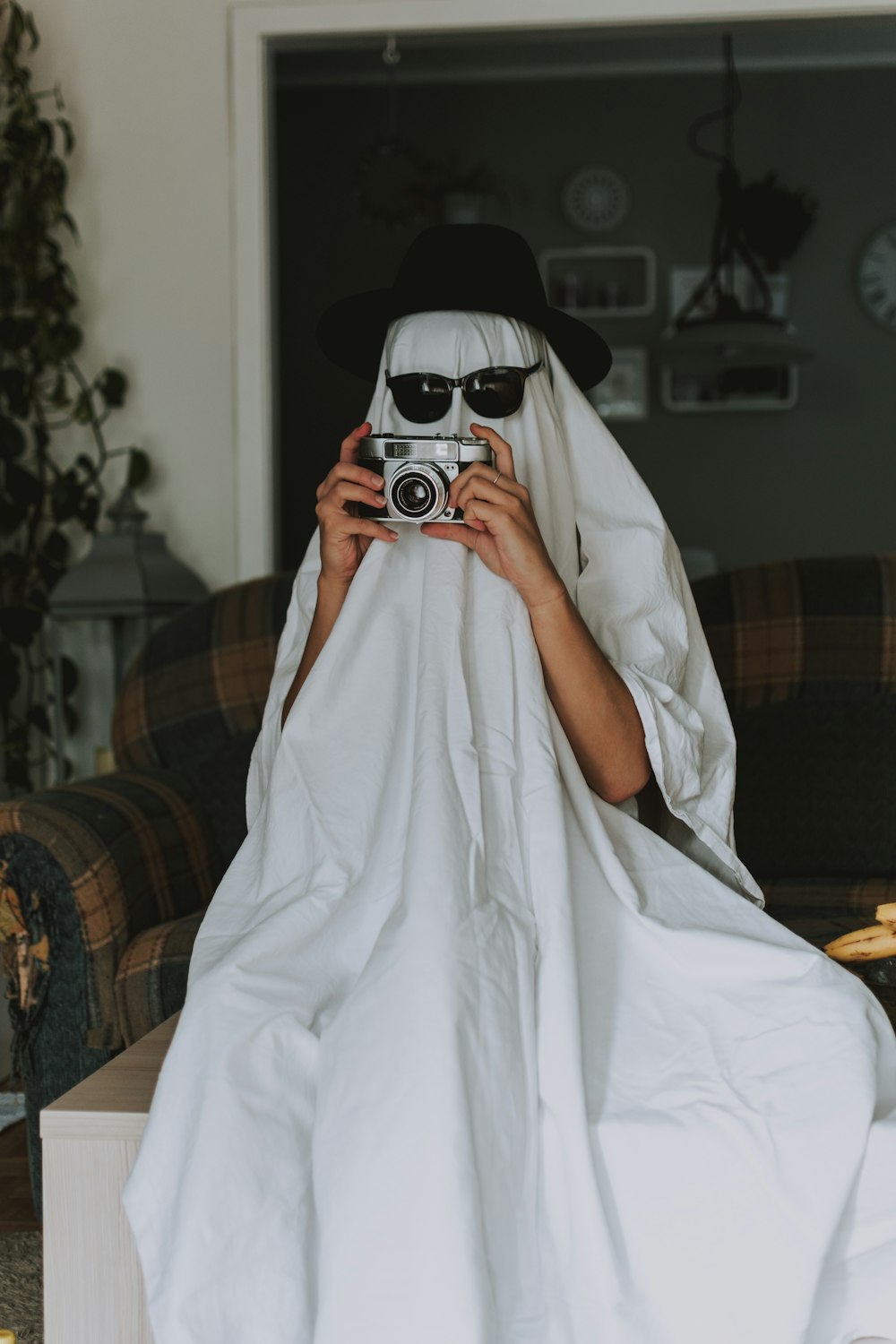 person holding white and black camera