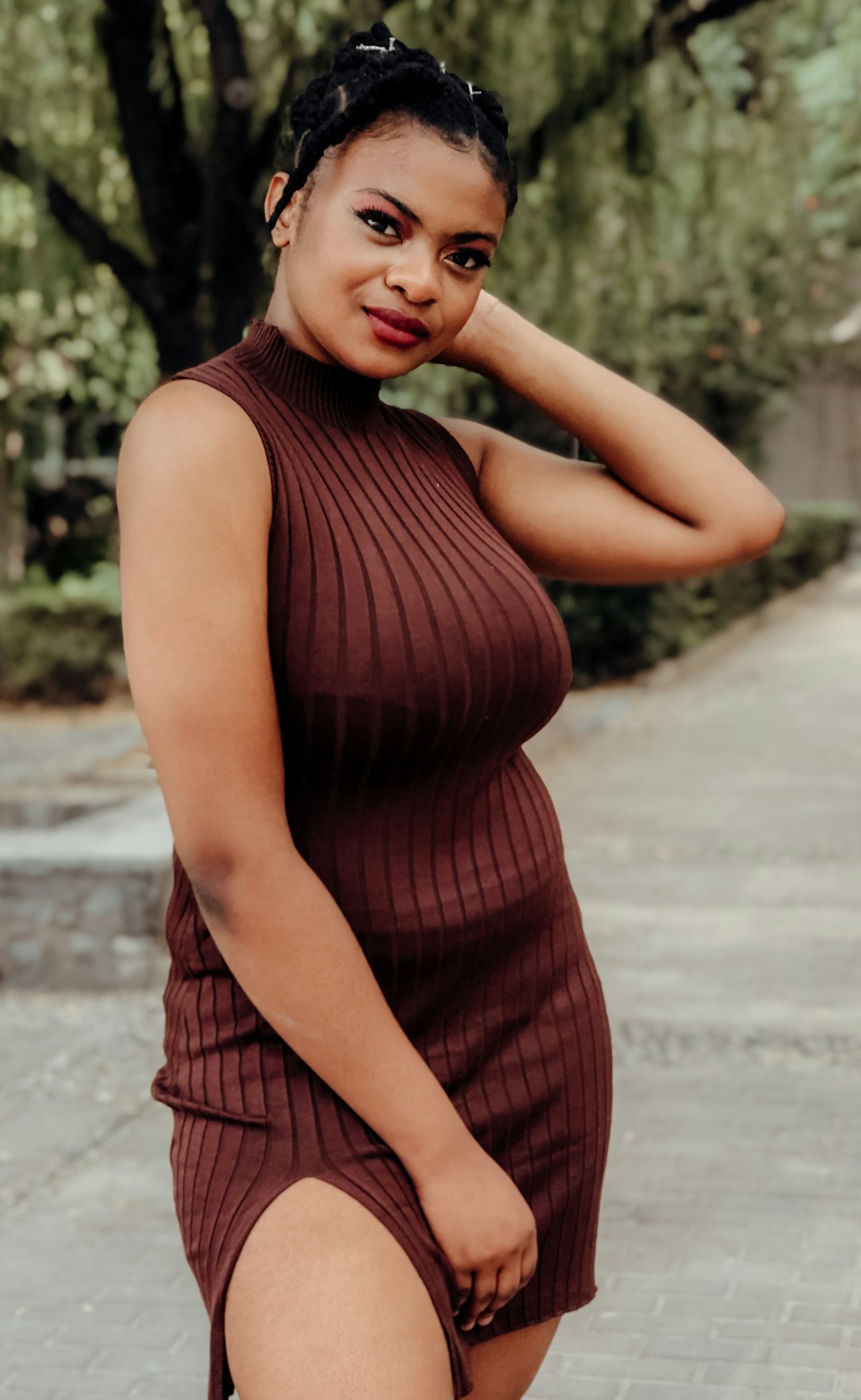 woman in black and red tank dress standing on road during daytime