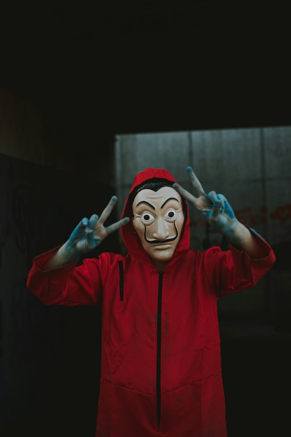 person in red hoodie wearing mask