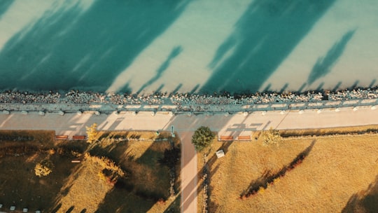 aerial view of green grass field near body of water during daytime in Balatonkenese Hungary