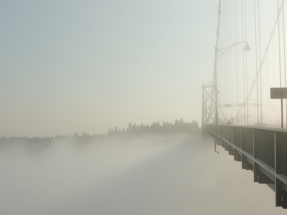 bridge over water during foggy weather