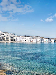 white concrete building beside body of water during daytime