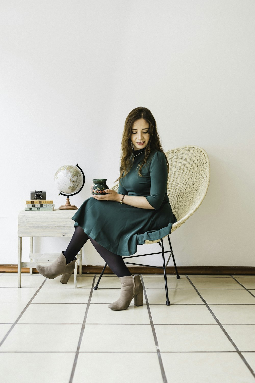 woman in green dress sitting on chair