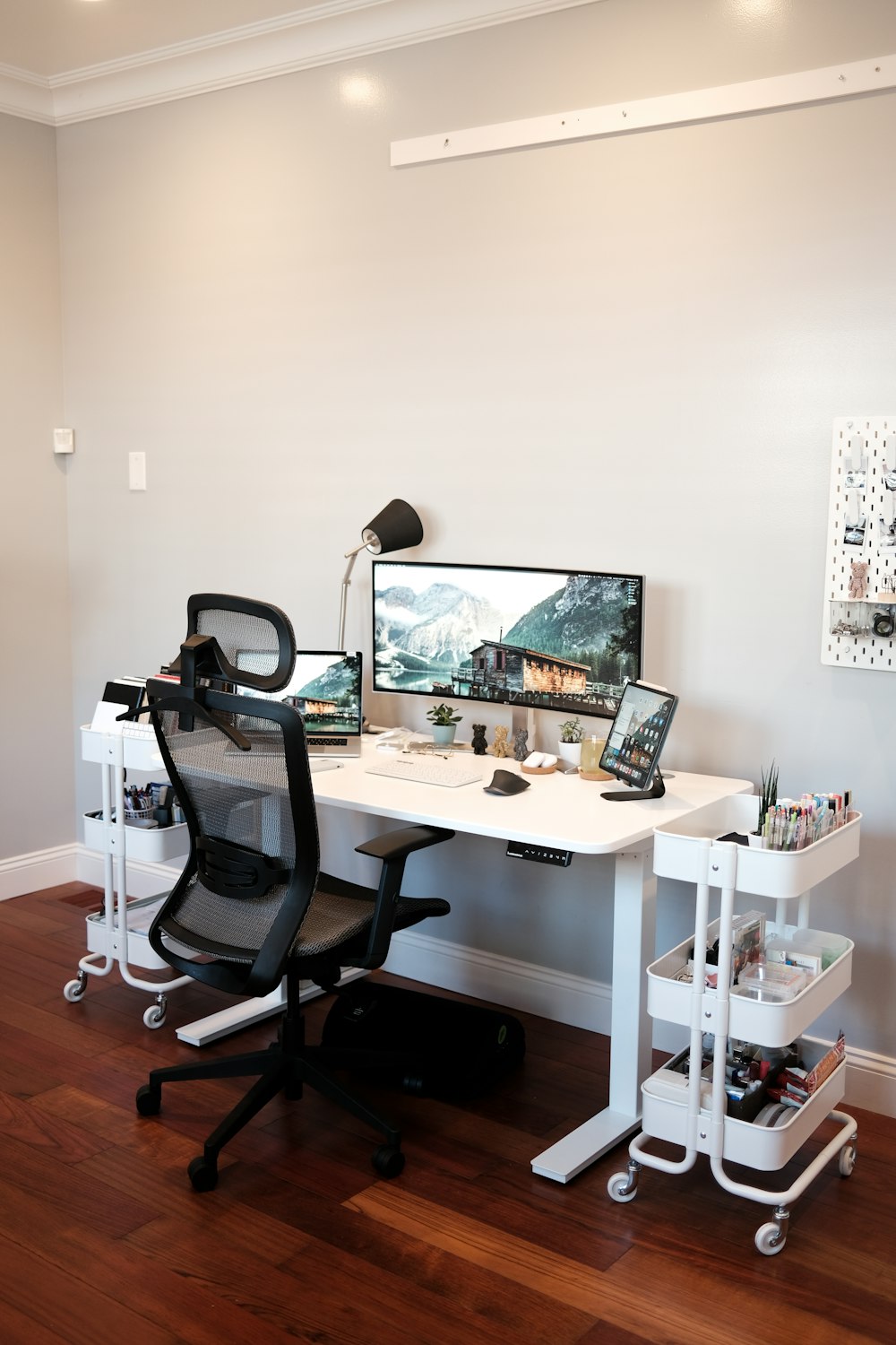 black flat screen computer monitor on white wooden desk