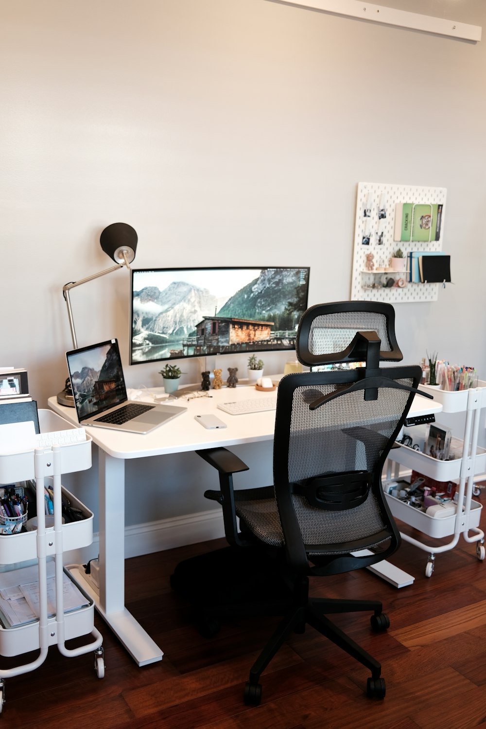 black rolling chair beside white wooden table