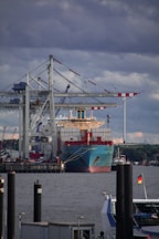 red and white cargo ship on dock during daytime