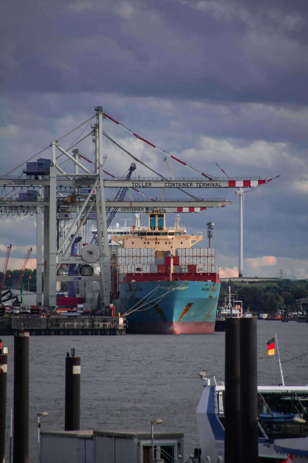 red and white cargo ship on dock during daytime