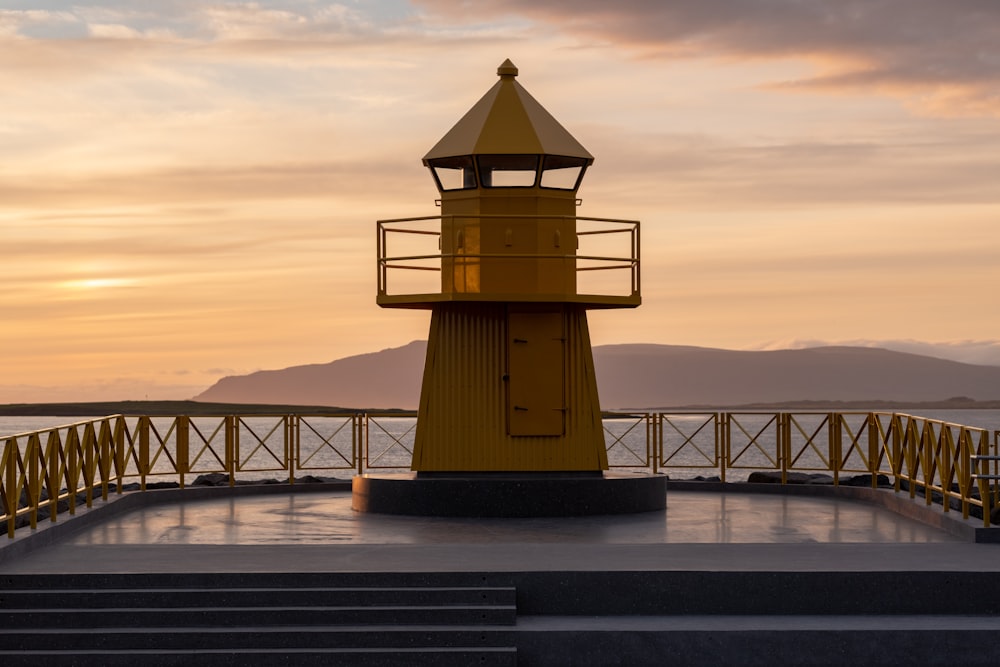 silhouette of lighthouse during sunset