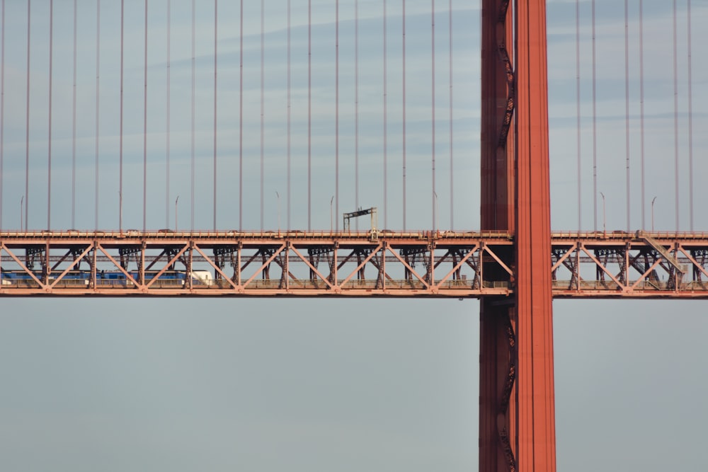 brown metal bridge under white sky during daytime