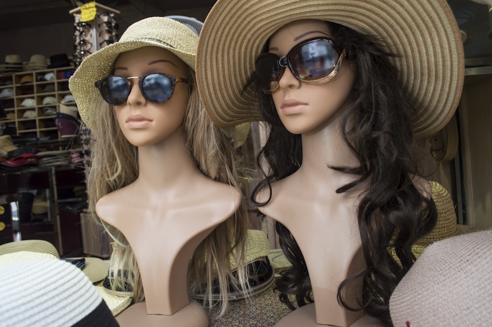 woman in black and white stripe tank top wearing brown sun hat and black sunglasses