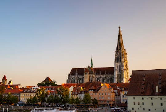 brown and white concrete buildings under blue sky during daytime in Steinerne Brücke Germany