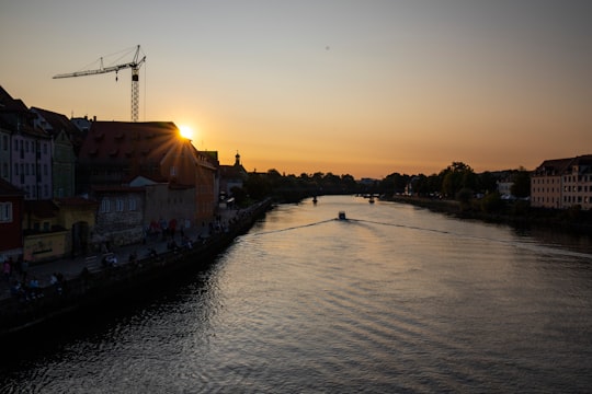 boat on water near buildings during sunset in Regensburg Germany