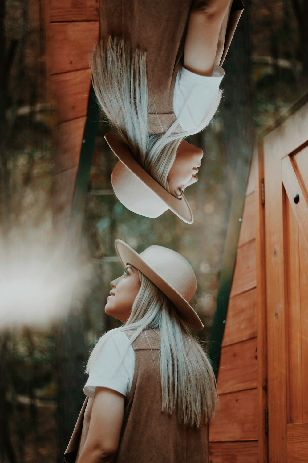 woman in white shirt wearing brown cowboy hat