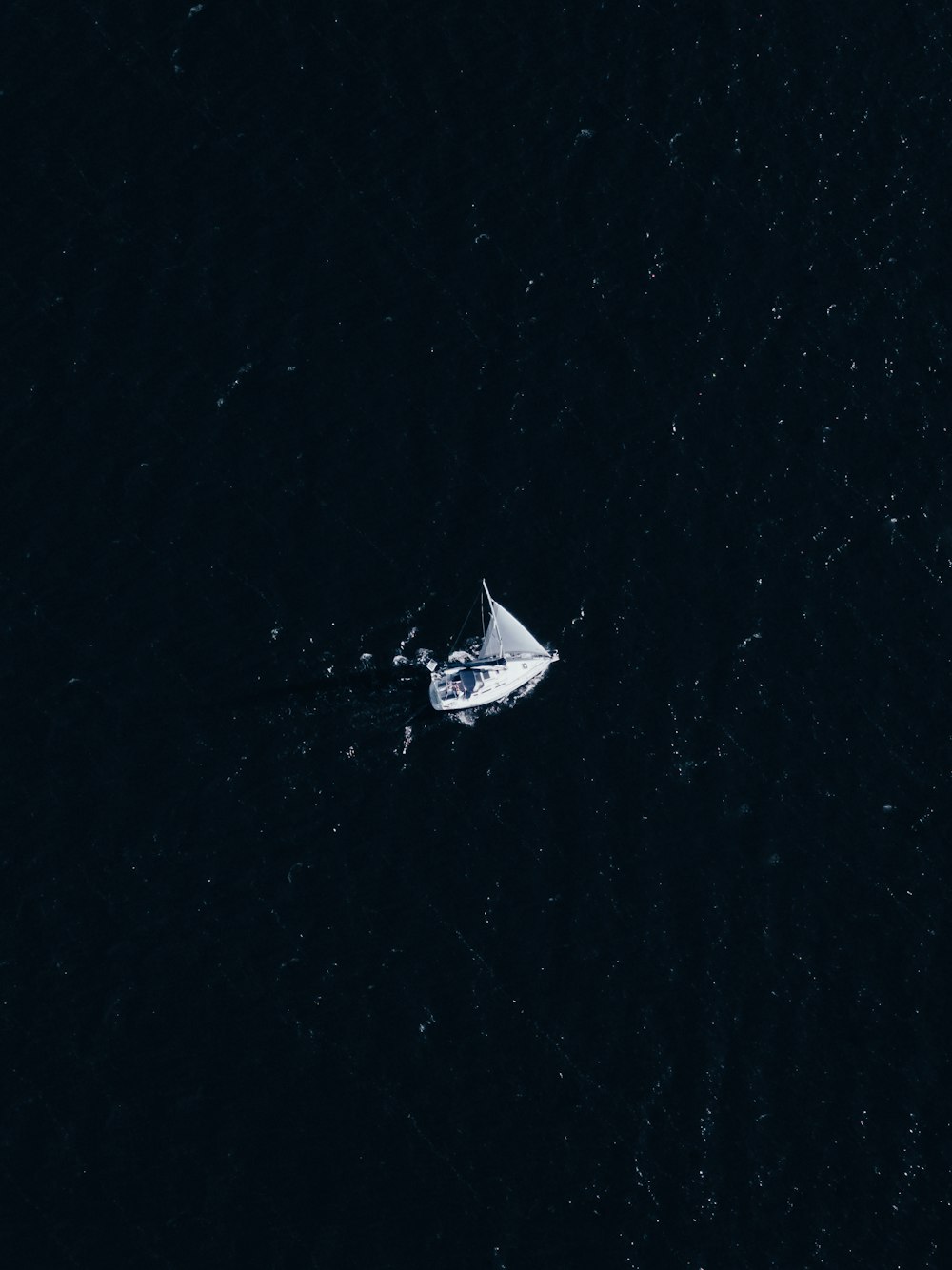 white boat on water during night time