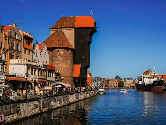 People walking on sidewalk near body of water during daytime — Gdańsk, Poland