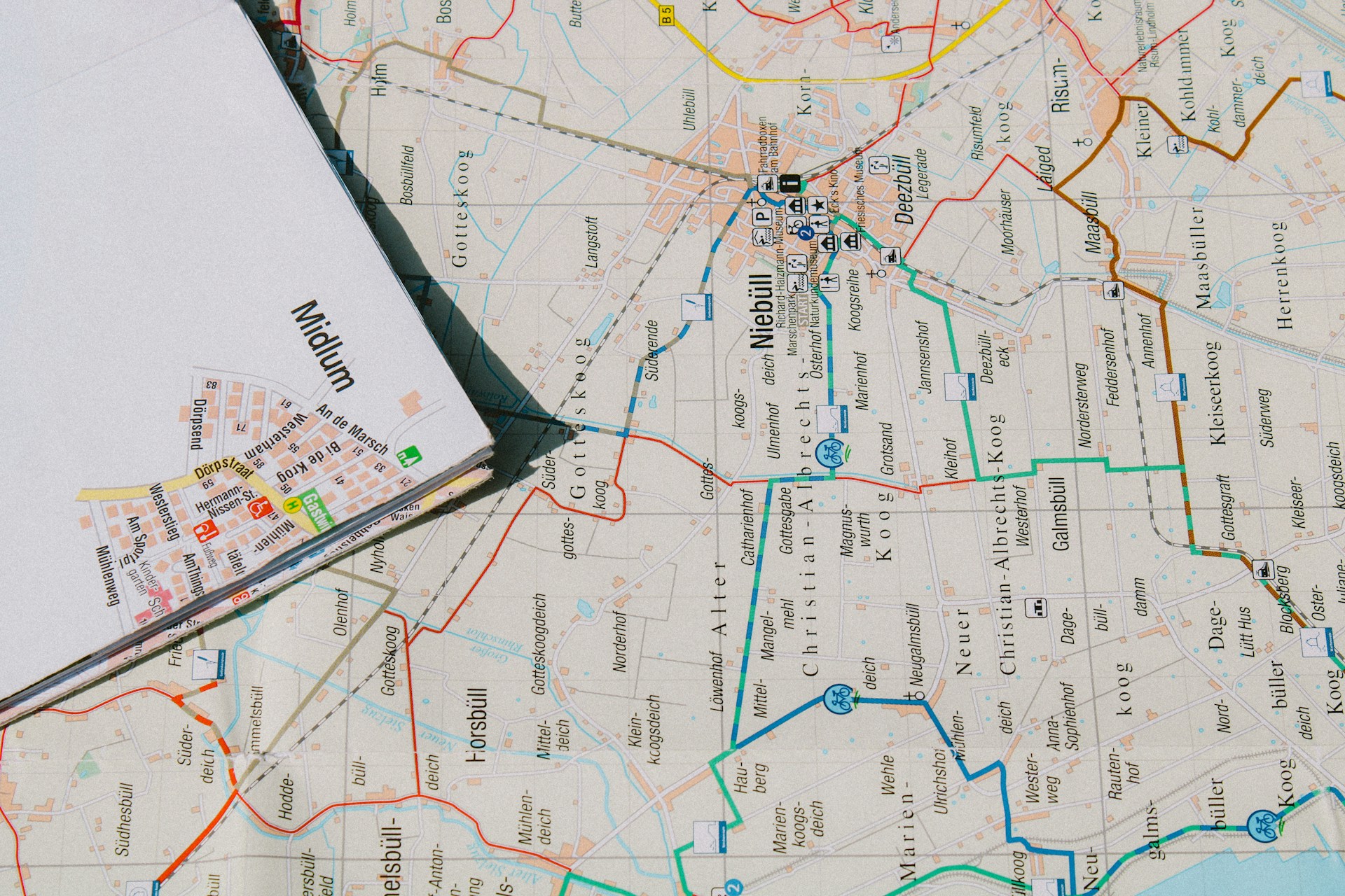 white printer paper on white and yellow map