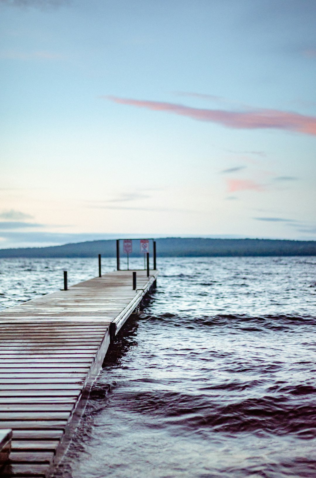 brown wooden dock on sea during sunset