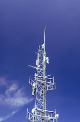 white and black windmill under blue sky during daytime