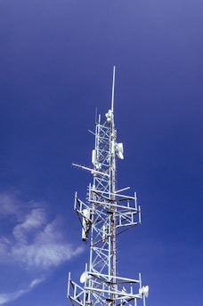 white and black windmill under blue sky during daytime