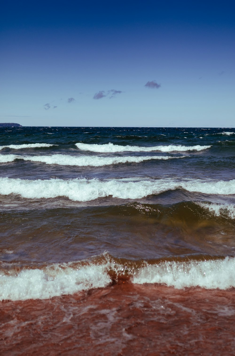 ocean waves crashing on shore during daytime