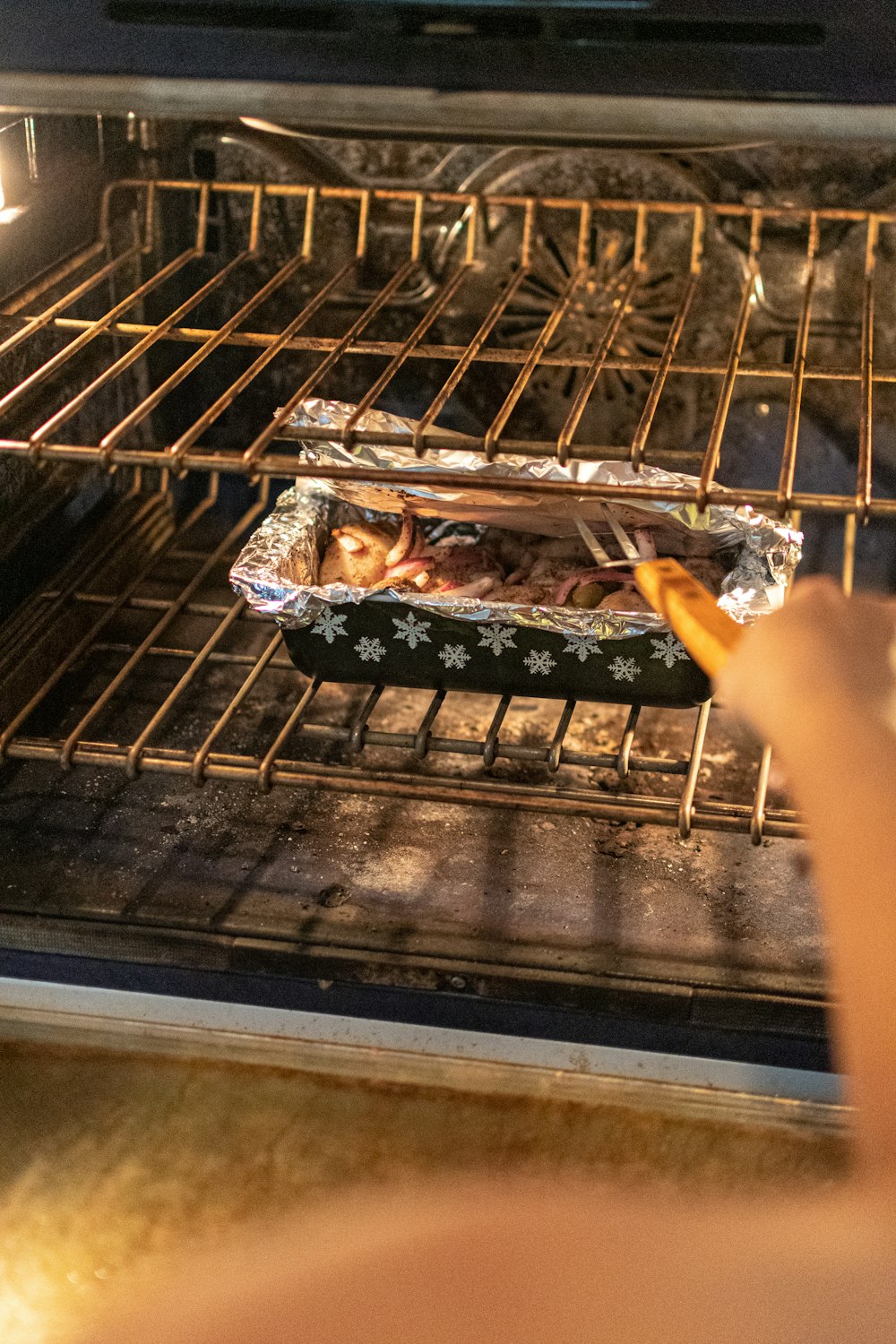 person holding grilled meat on black tray