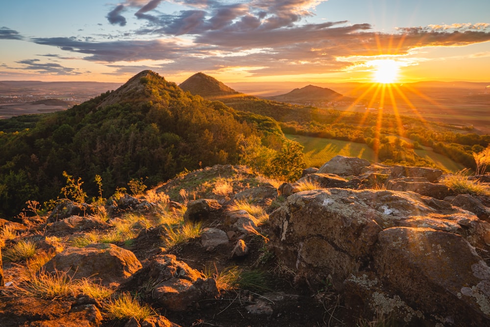 green grass on brown mountain during sunset