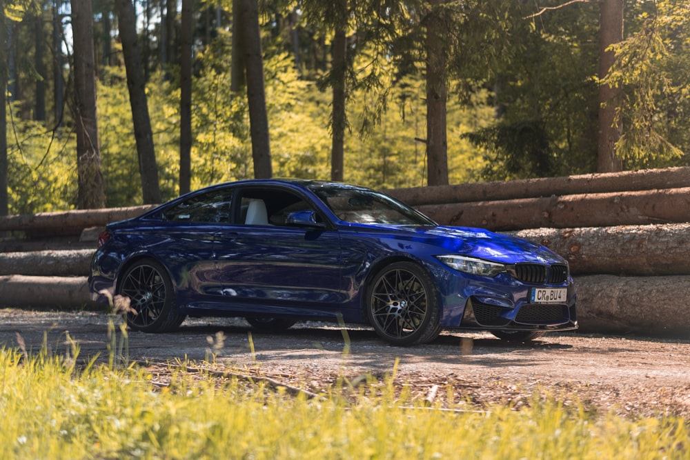 blue coupe parked on the road