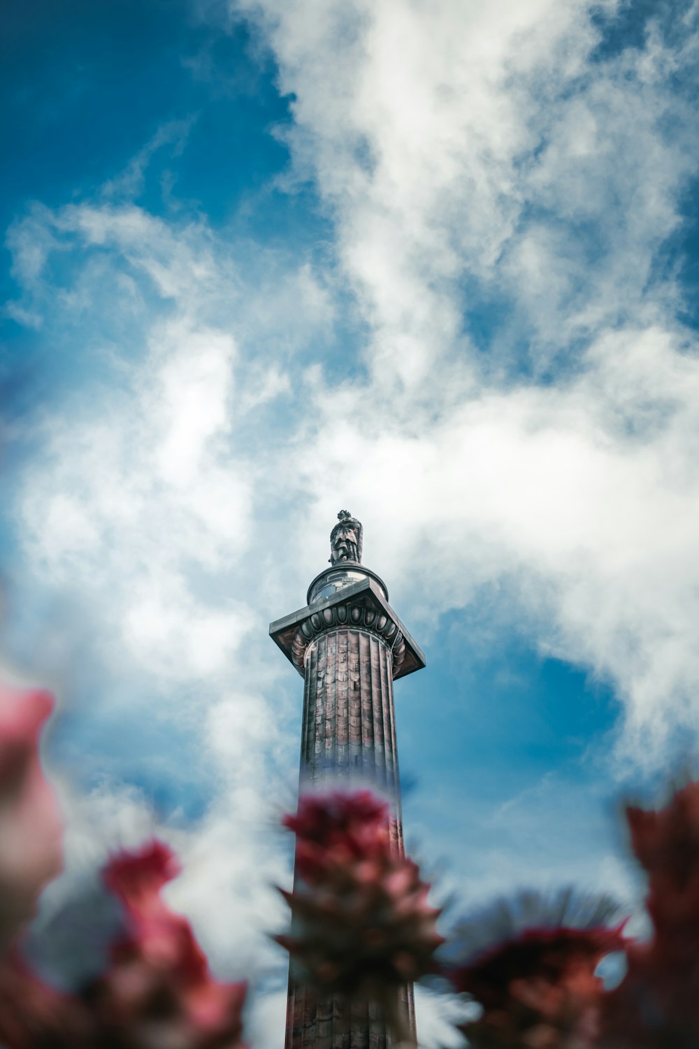 black tower under white clouds and blue sky during daytime