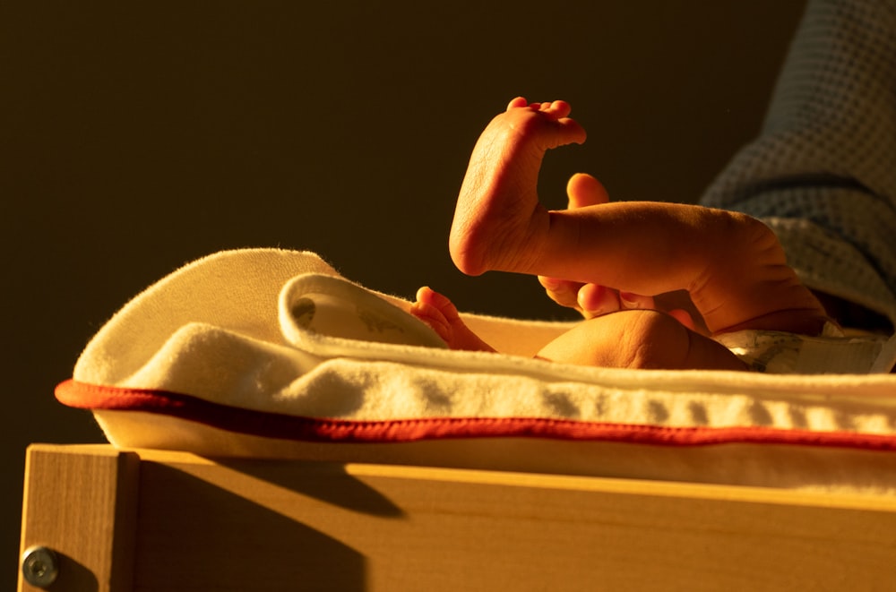 persons feet on brown wooden table