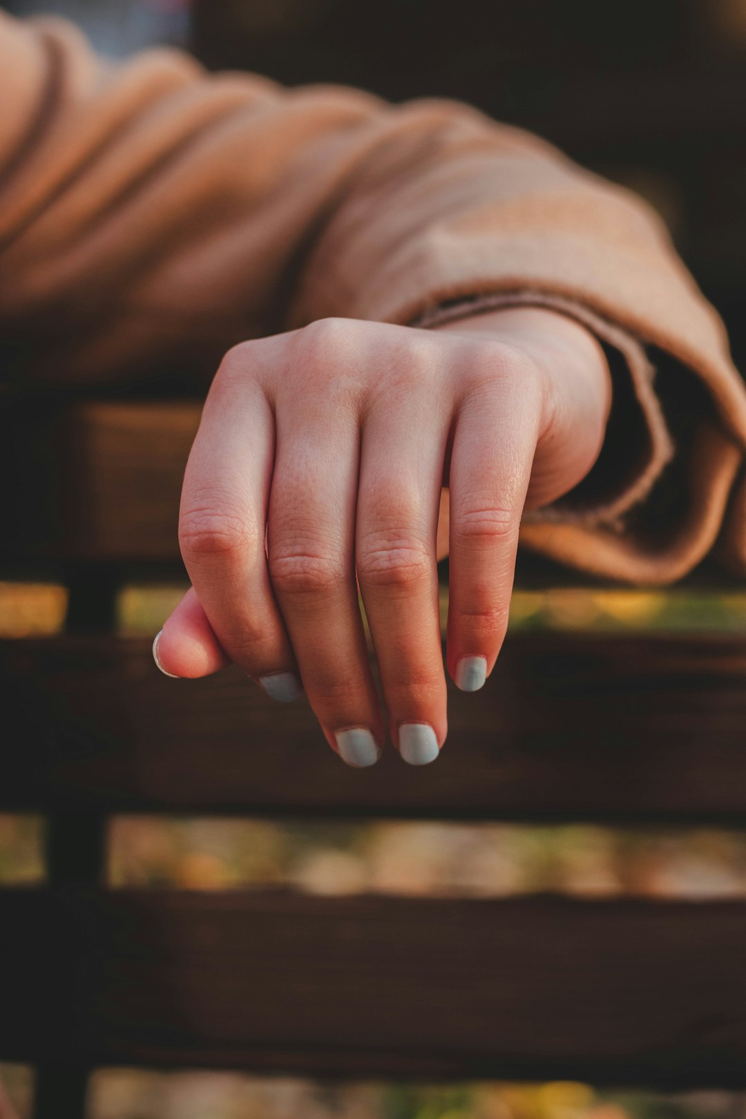 person with white manicure on left hand