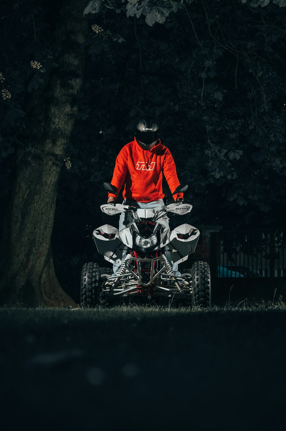 Mann in roter Jacke auf weiß-schwarzem Motorrad