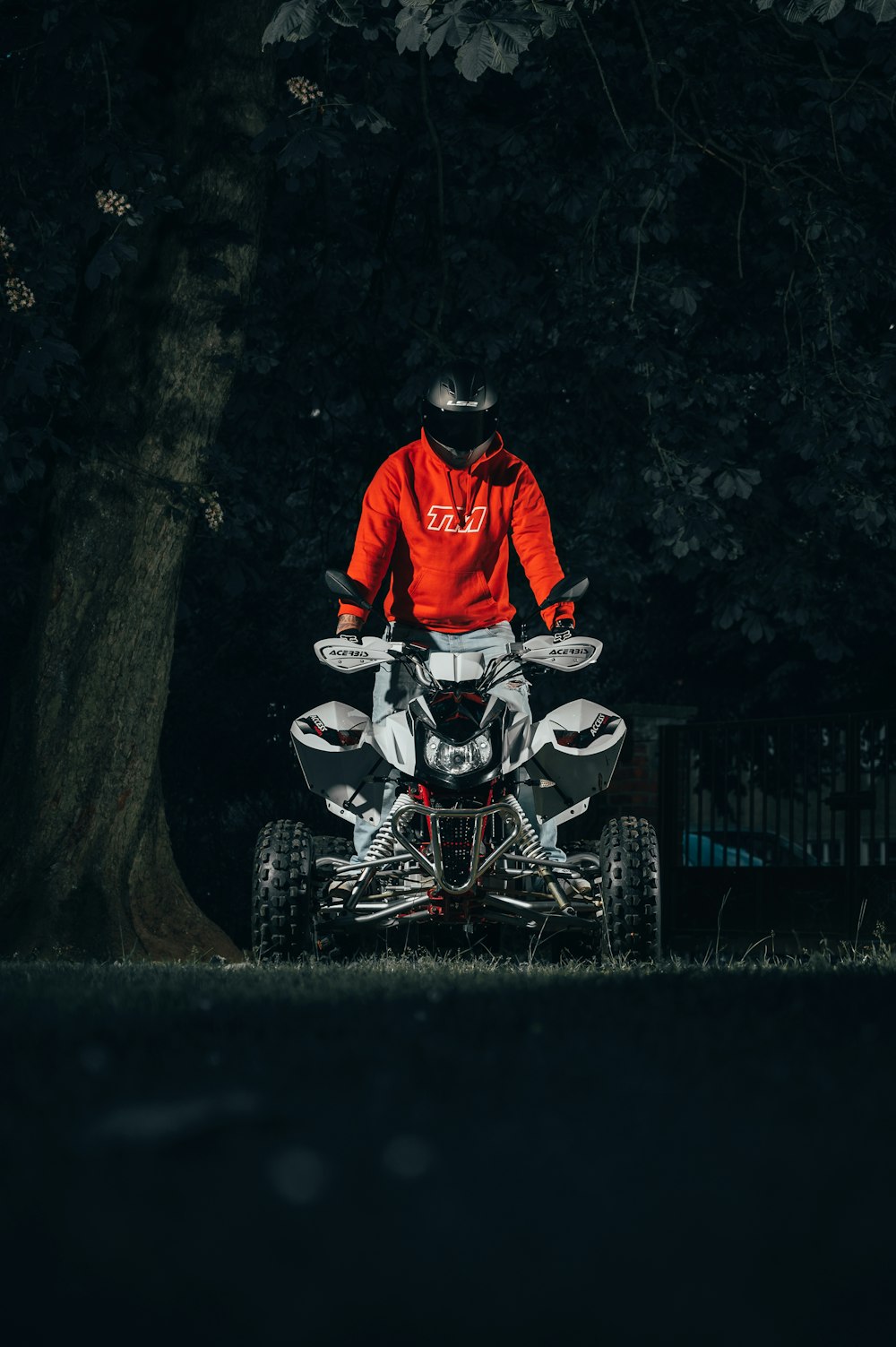 man in red jacket riding on white and black motorcycle