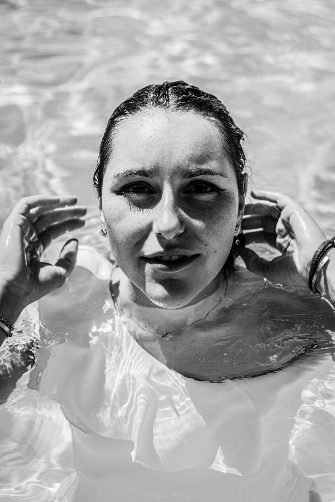 woman in water in grayscale photography