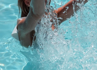 woman in white bikini top in water