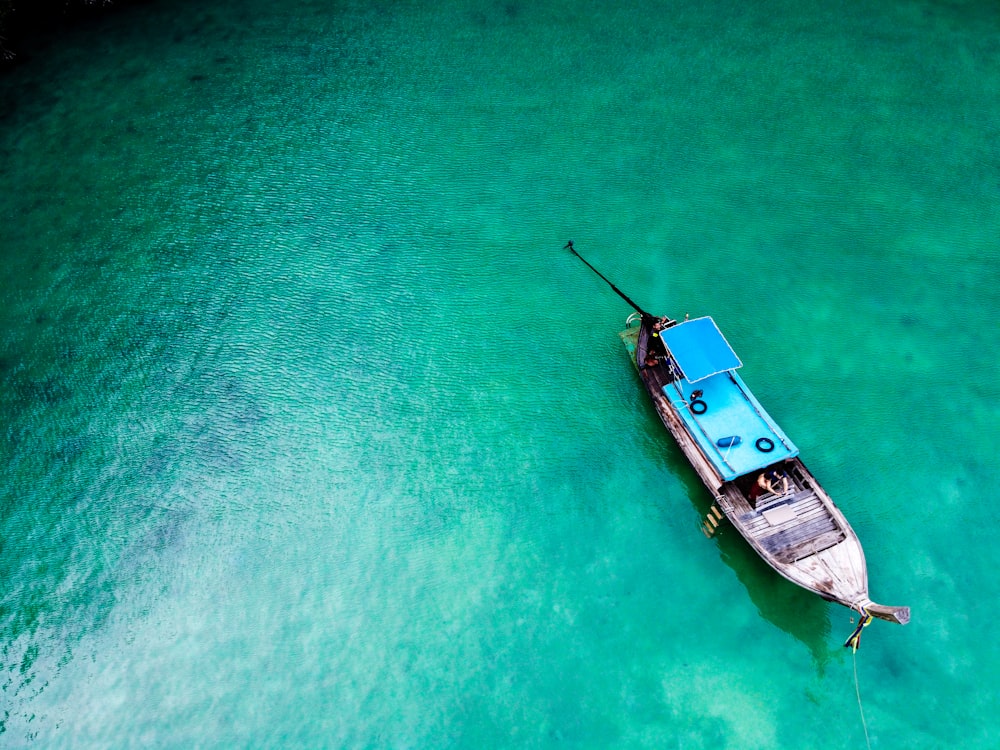 aerial view of white and brown boat on body of water during daytime