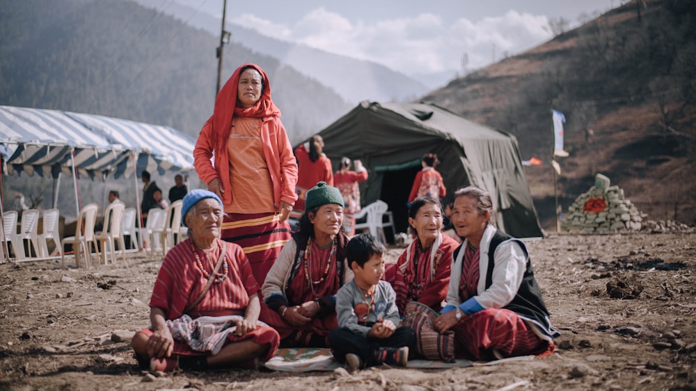 group of people sitting on ground during daytime