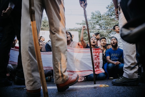 people sitting on red and white tent during daytime
