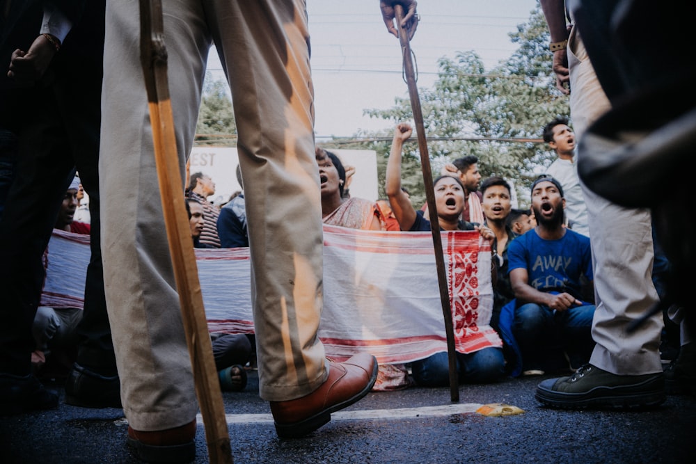 people sitting on red and white tent during daytime