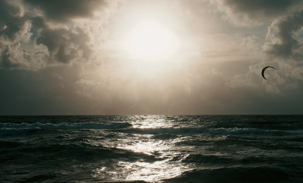 ocean waves under white sky during daytime