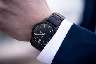 black and silver round analog watch