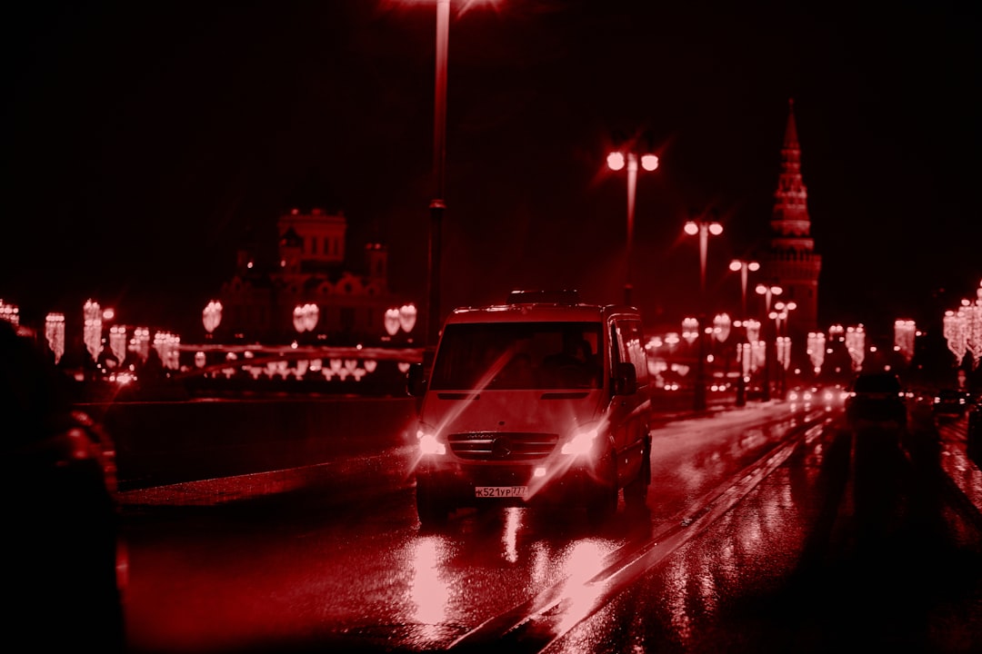 black car on road during night time