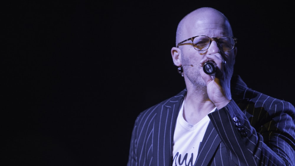 man in black and white striped shirt wearing black sunglasses