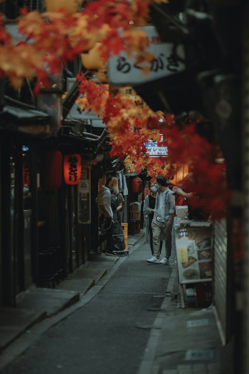 people walking on street with red fire during nighttime