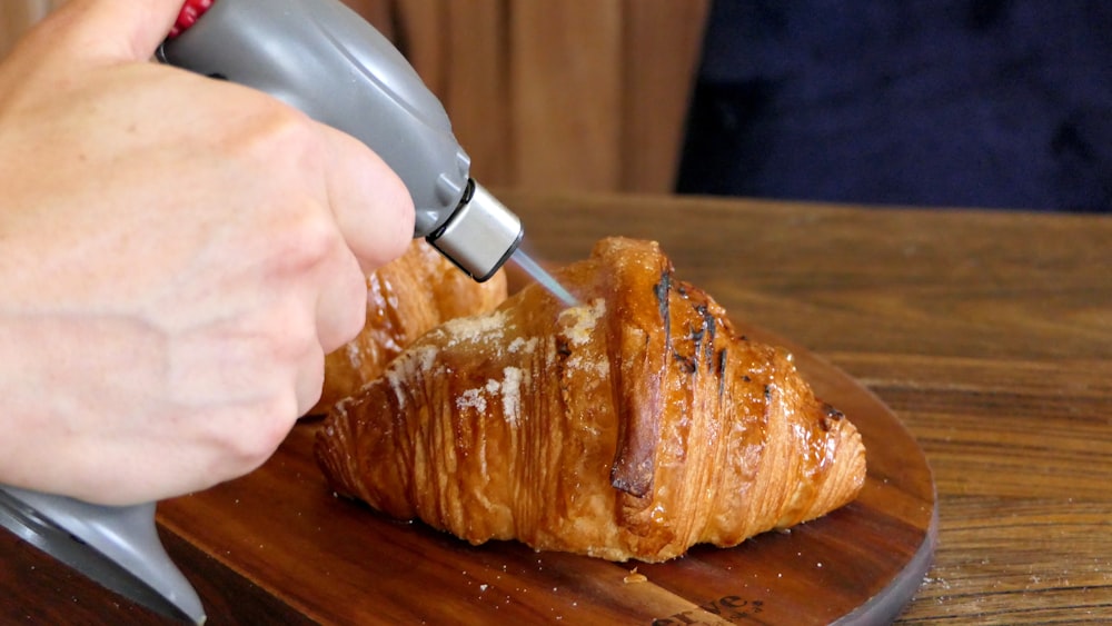 person holding knife slicing meat